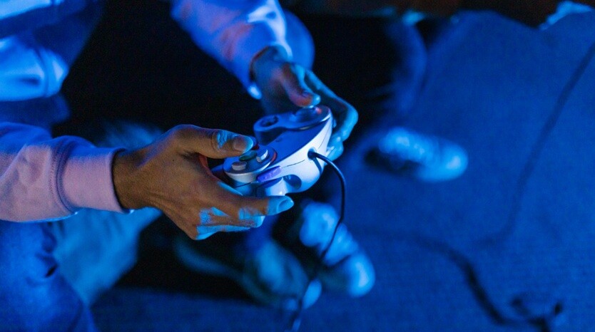 a person playing an online game with a joystick in the room