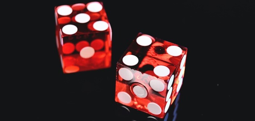two dice in red color being rolled in the black background