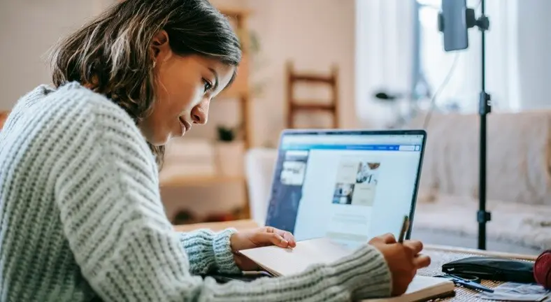 a student studying from an online class using laptop