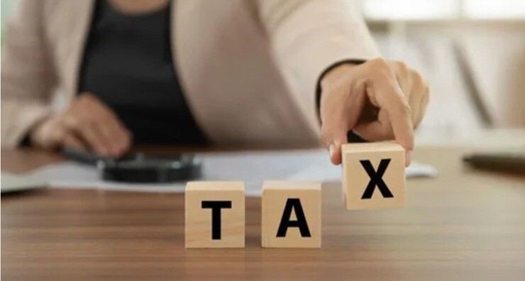 a lady holding the letter tax on her hand