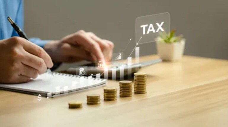 a person typing on the calculator with tax written on the side