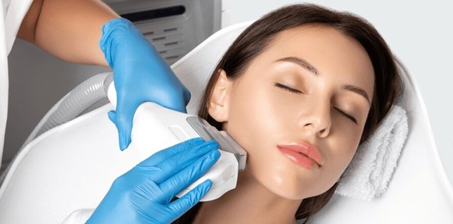 IPL treatment done a lady face with a person wearing gloves