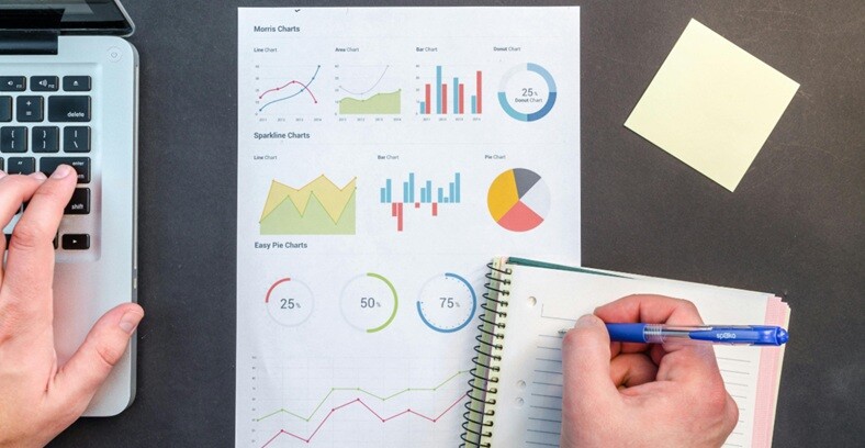 SEO graphs and charts seen in a paper and person hand is writing notes