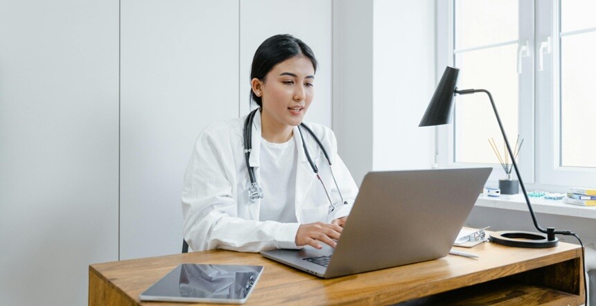 a doctor working on a computer vision laptop