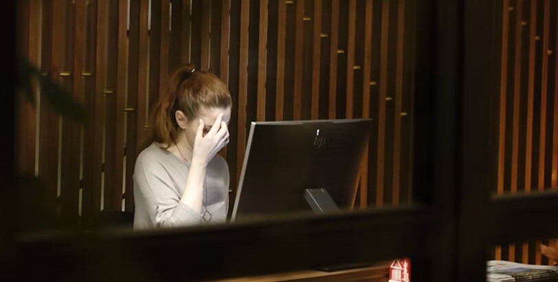 a lady placing her hand on her head because of headache