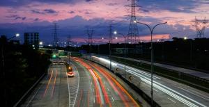 city highway during night with streetlights and evening clouds