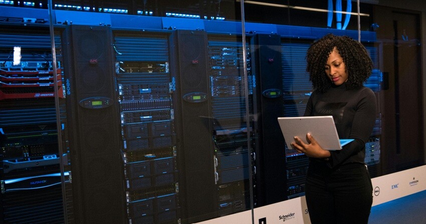 a lady walking beside data storage service in a company setup