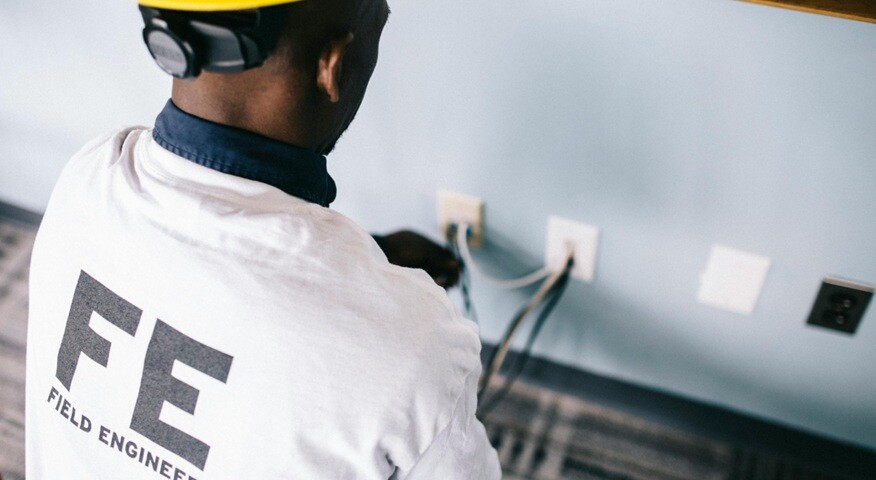 field engineer a person with field engineer written on his shirt working on wires