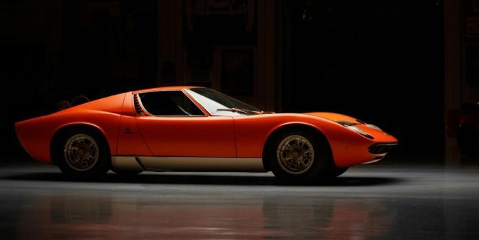 a red Lamborghini Miura with black background a rare piece