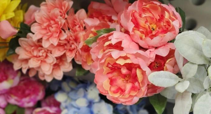 a bunch of colorful faux flowers grouped together