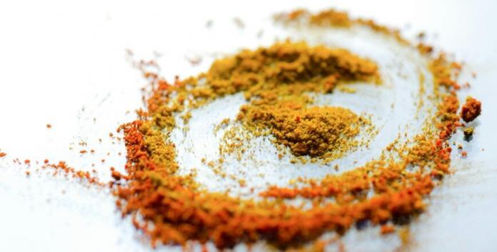 Macca powder placed on the table in powder form in brown color