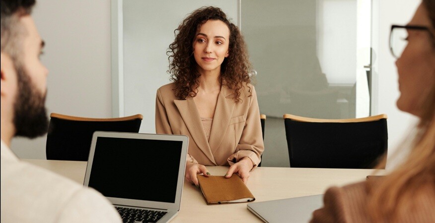 recruitment a lady being interviewed by two persons in an office setup