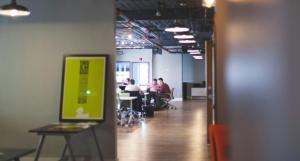 an office space where a group of people are working with lights on