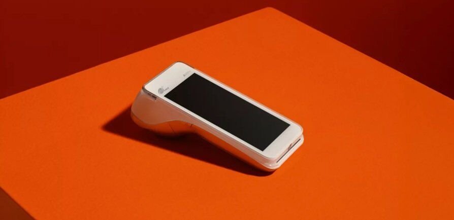 a POS device seen in an orange background