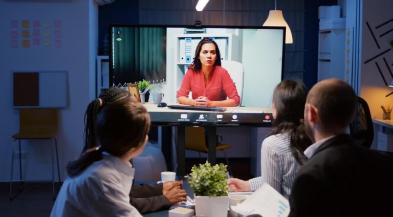 Employees participating in video-based workplace training through a virtual meeting.